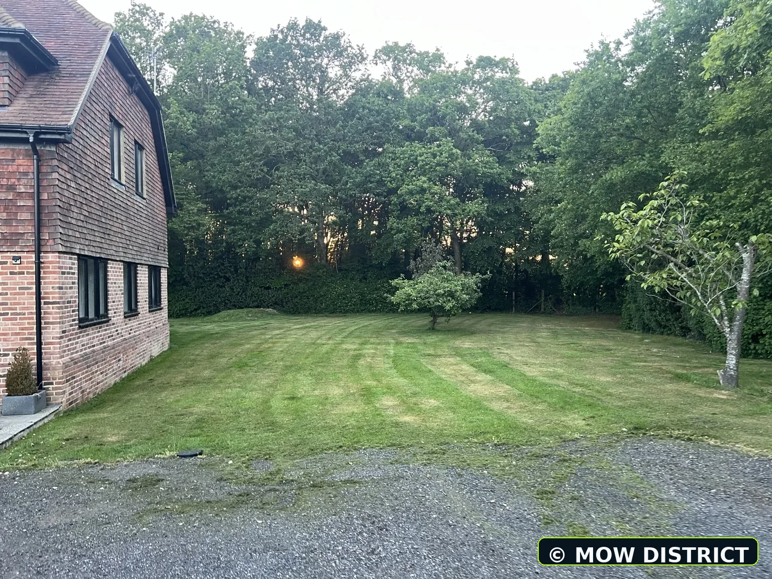 Large rear lawn freshly mown with stripes